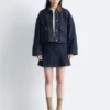 Kurze Jeansjacke mit Cordkragen
